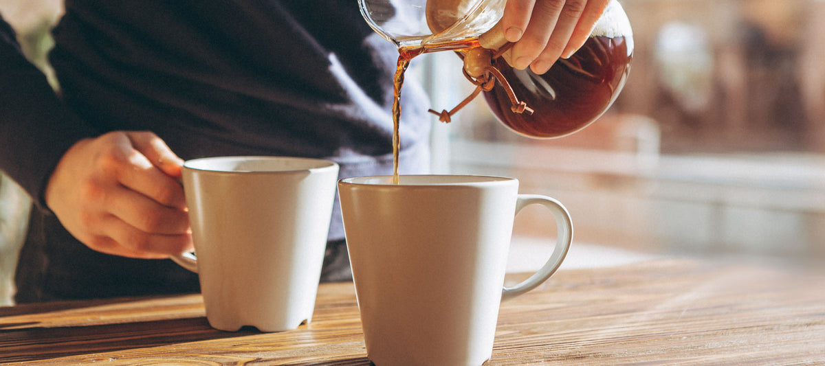 Barista serving coffee to a customer, highlighting the customer service aspect of coffee conversations