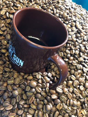 Desert Sun mug in fresh coffee beans